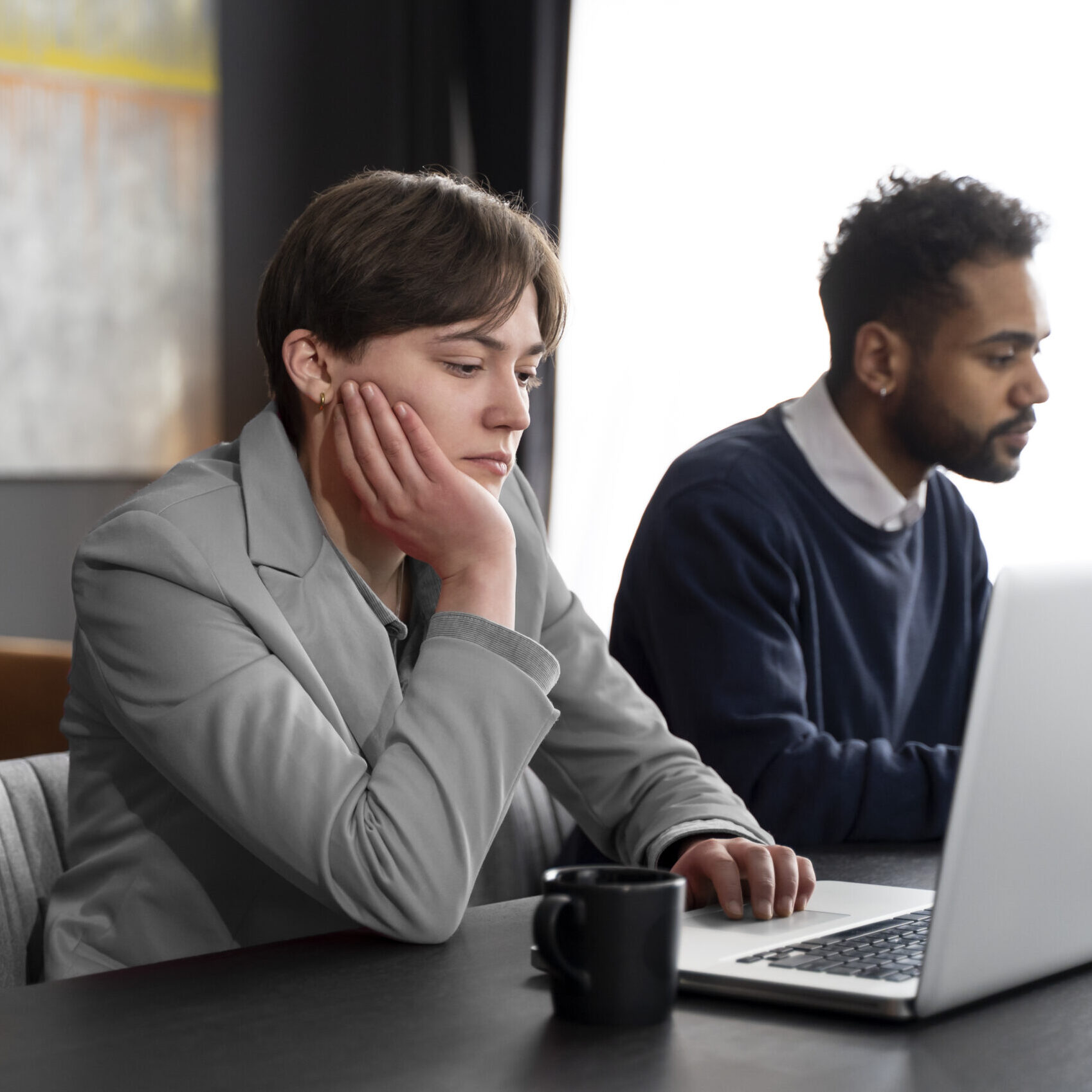 trans person working office with colleagues